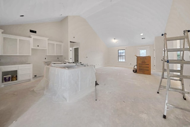 unfurnished living room with vaulted ceiling