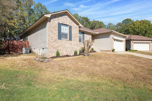 view of front of home with cooling unit, a front yard, and a garage