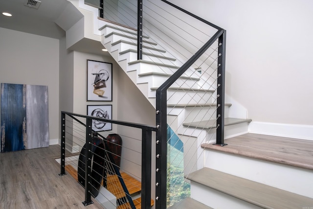 stairway with wood-type flooring