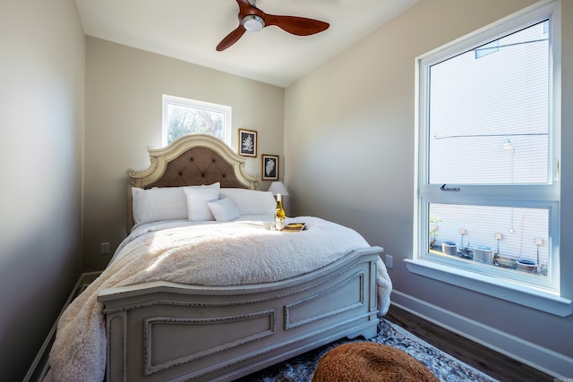 bedroom with ceiling fan and dark hardwood / wood-style flooring