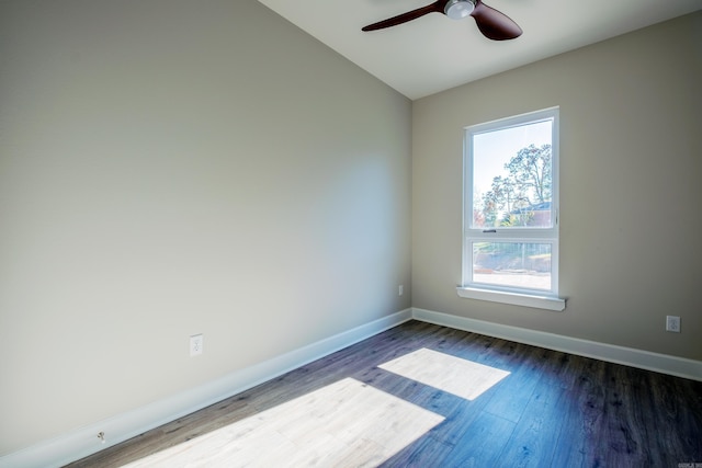 spare room with ceiling fan and dark wood-type flooring