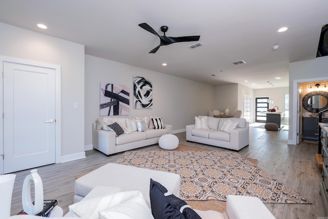 living room featuring ceiling fan and light wood-type flooring