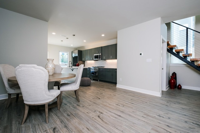 dining room with light hardwood / wood-style floors and sink