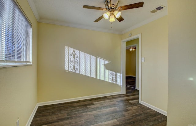 spare room with dark hardwood / wood-style floors, ceiling fan, and crown molding