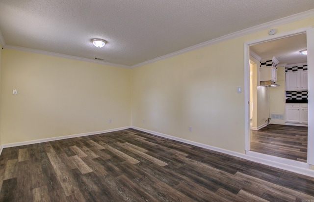 empty room with a textured ceiling, crown molding, and dark wood-type flooring