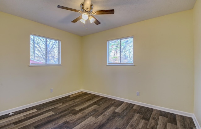 unfurnished room with dark hardwood / wood-style floors and ceiling fan