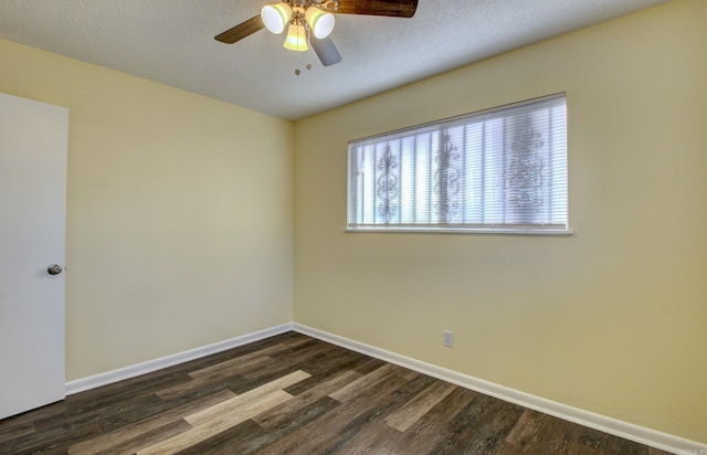 spare room featuring ceiling fan, dark hardwood / wood-style floors, and a textured ceiling