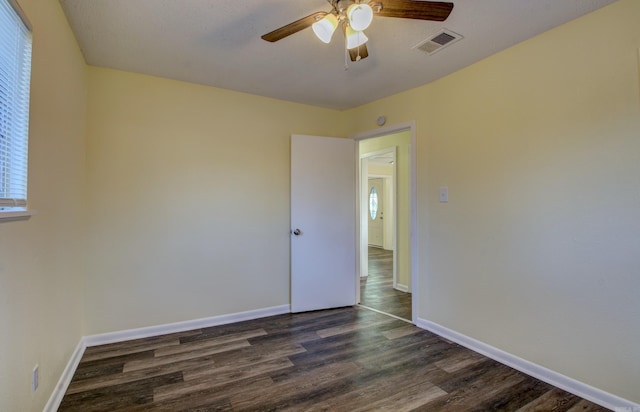 empty room featuring ceiling fan and dark hardwood / wood-style flooring