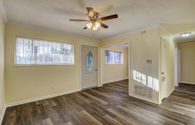 foyer entrance featuring a textured ceiling, dark hardwood / wood-style flooring, ceiling fan, and crown molding