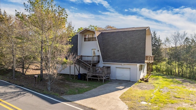 view of front of house featuring a garage and a wooden deck