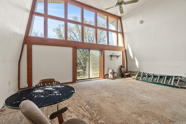 living room with ceiling fan and high vaulted ceiling