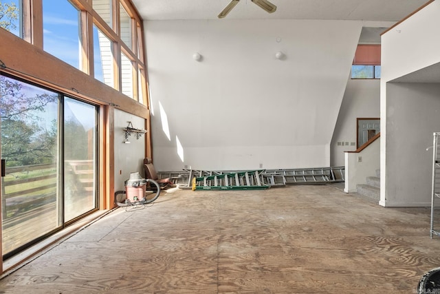 interior space featuring ceiling fan and a towering ceiling