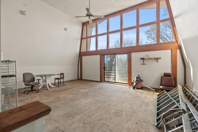 living room featuring ceiling fan, plenty of natural light, and vaulted ceiling