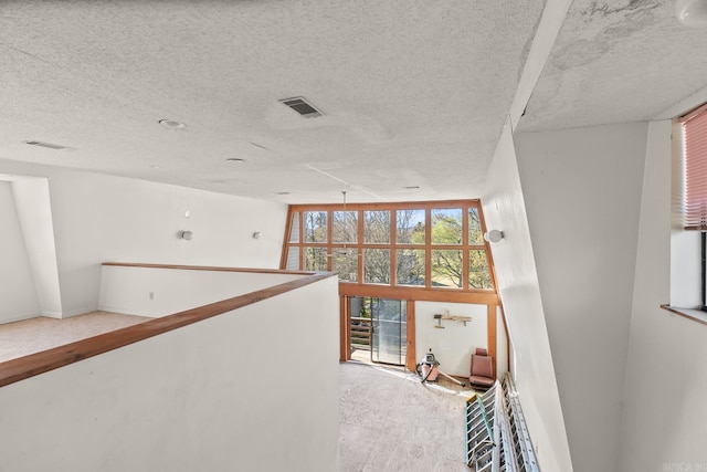 hallway with a textured ceiling