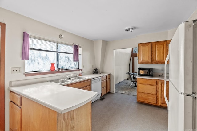 kitchen featuring kitchen peninsula, sink, and white appliances