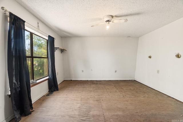 empty room featuring ceiling fan and a textured ceiling