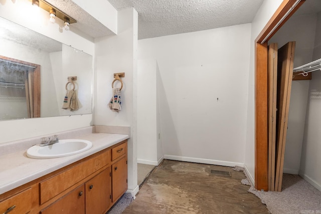 bathroom with vanity and a textured ceiling