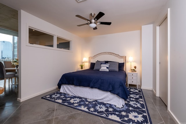 bedroom featuring dark tile patterned floors and ceiling fan