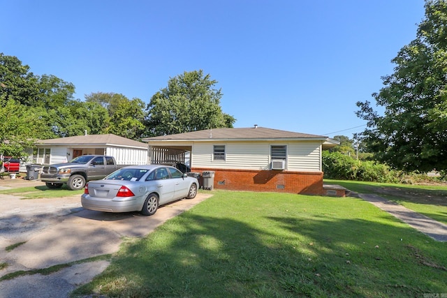 view of front facade featuring a carport, cooling unit, and a front lawn