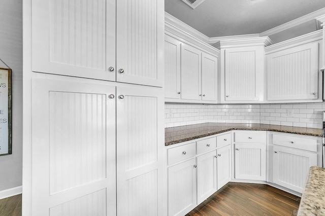 kitchen with white cabinets, dark wood-type flooring, and dark stone countertops