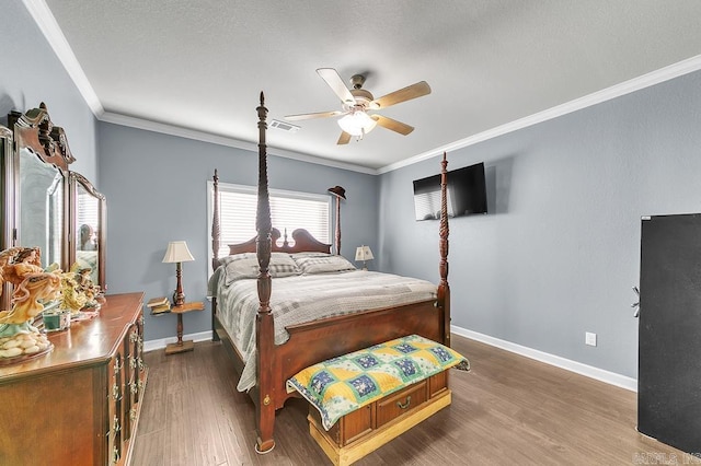 bedroom with ceiling fan, dark hardwood / wood-style flooring, and ornamental molding