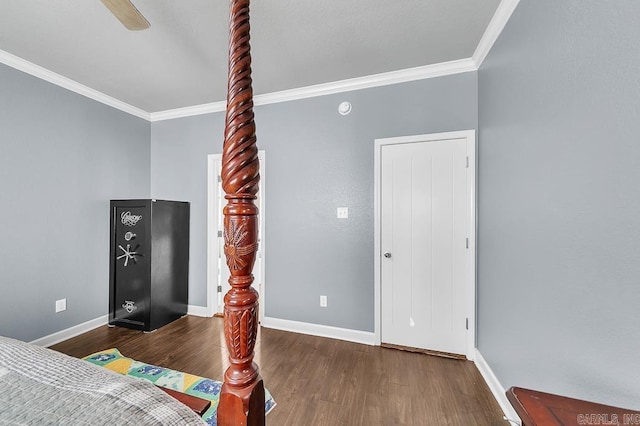 bedroom featuring dark hardwood / wood-style floors, ceiling fan, and crown molding