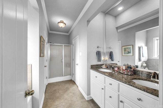 bathroom featuring tile patterned flooring, vanity, a shower with door, and crown molding