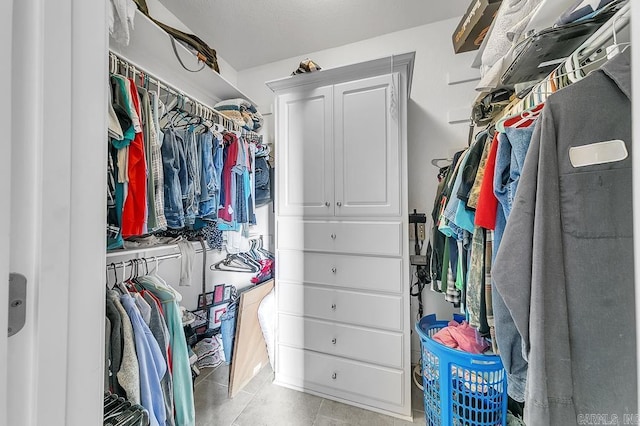 spacious closet with light tile patterned floors