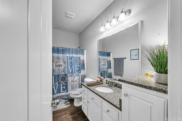 bathroom with a shower with curtain, vanity, and toilet