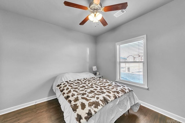 bedroom featuring ceiling fan and dark wood-type flooring