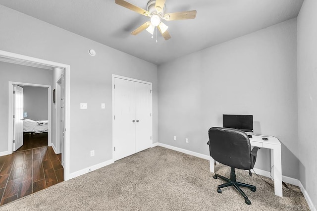 carpeted office with ceiling fan