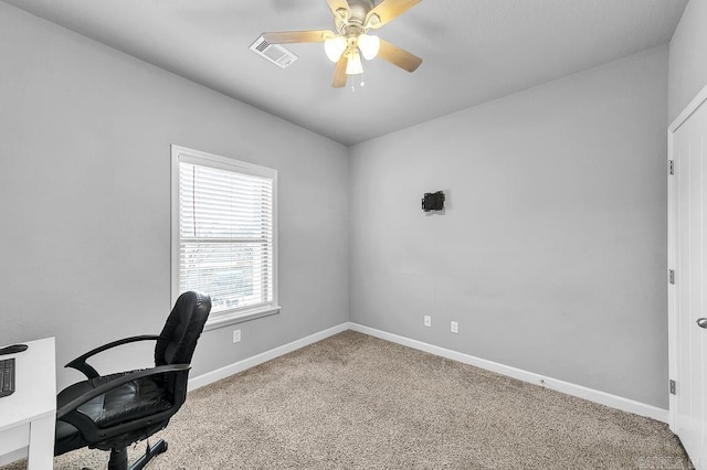 carpeted home office with ceiling fan