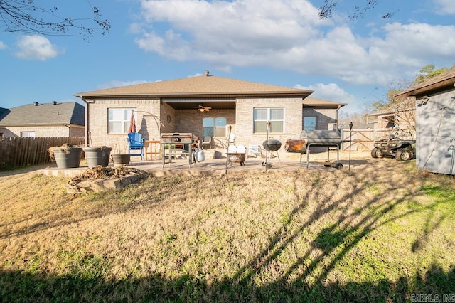 rear view of house featuring a lawn, ceiling fan, and a patio area