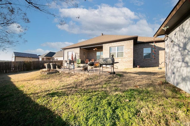 back of house featuring a yard, a patio, and ceiling fan