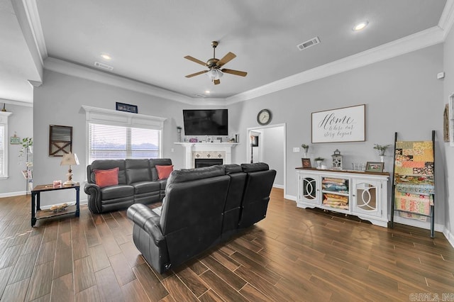 living room with ceiling fan, a fireplace, and crown molding