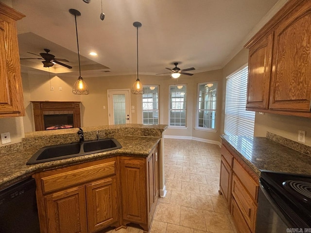 kitchen featuring a wealth of natural light, sink, pendant lighting, and black dishwasher