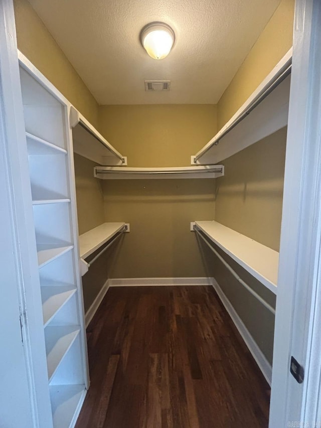 walk in closet featuring dark hardwood / wood-style floors