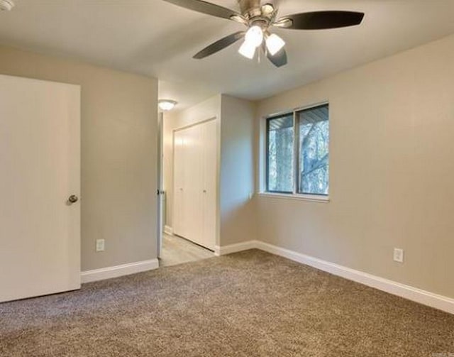 carpeted empty room with ceiling fan