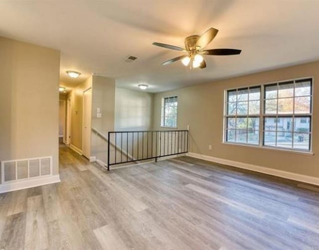 spare room with ceiling fan and light hardwood / wood-style flooring