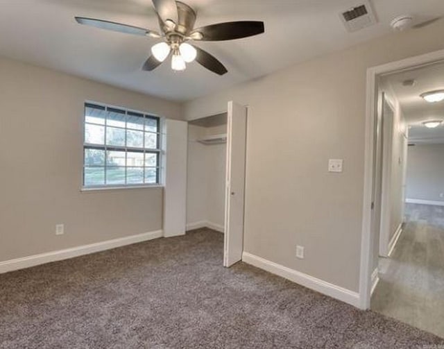 unfurnished bedroom with ceiling fan, a closet, and light colored carpet