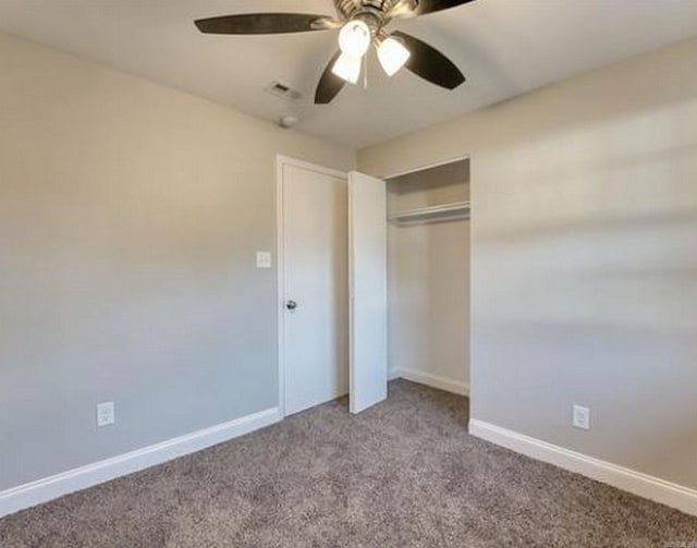 unfurnished bedroom featuring ceiling fan, carpet floors, and a closet