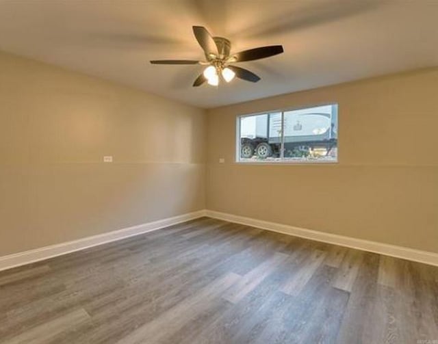 spare room featuring ceiling fan and dark hardwood / wood-style floors