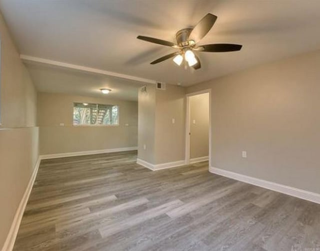 unfurnished room with hardwood / wood-style flooring and ceiling fan