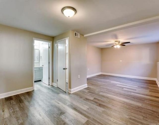 unfurnished room featuring hardwood / wood-style flooring and ceiling fan