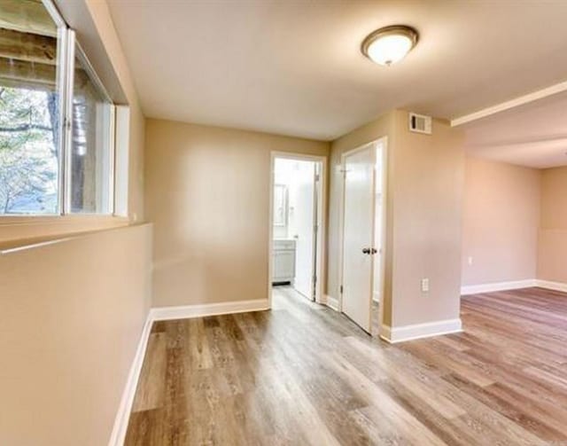 unfurnished room with wood-type flooring