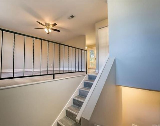 staircase with ceiling fan