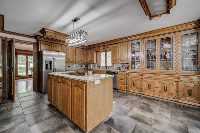 kitchen with a wealth of natural light, a kitchen island, pendant lighting, and appliances with stainless steel finishes