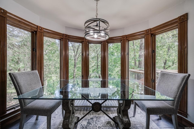 sunroom / solarium with an inviting chandelier