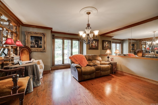 living room with wood-type flooring, crown molding, and a notable chandelier