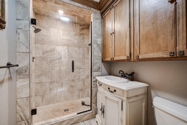 bathroom with vanity, toilet, and walk in shower